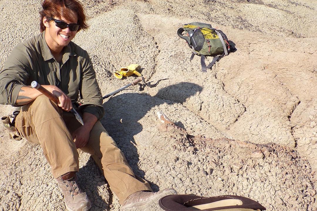A Carthage student next to a Triceratops skull that he discovered eroding from the ground in 2019.